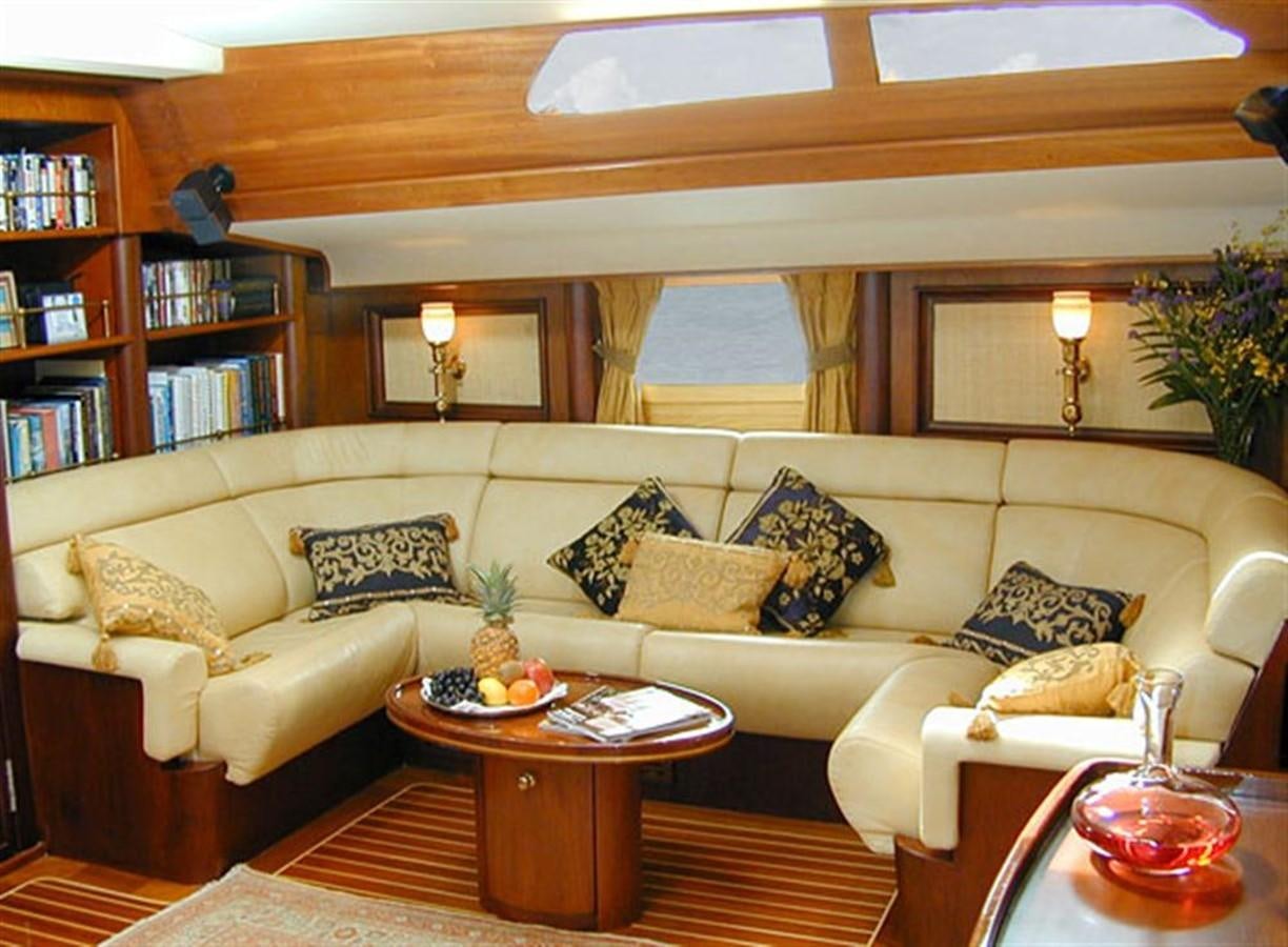 a living room with a couch and a coffee table aboard AURASTEL Yacht for Sale