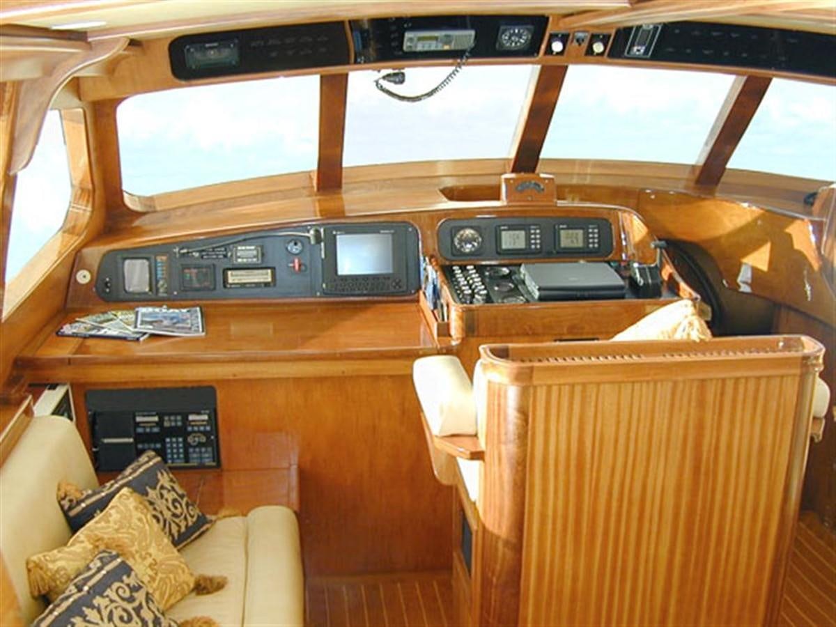a wooden shelf with electronics aboard AURASTEL Yacht for Sale