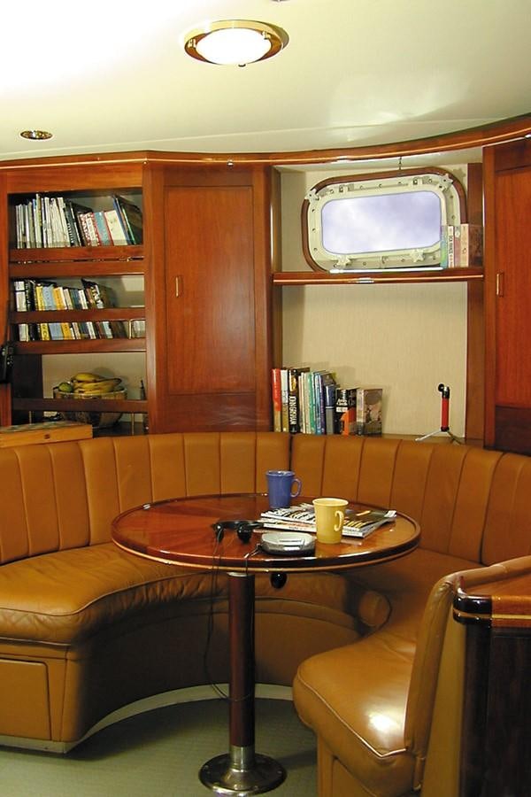 a small living room with a television aboard AURASTEL Yacht for Sale