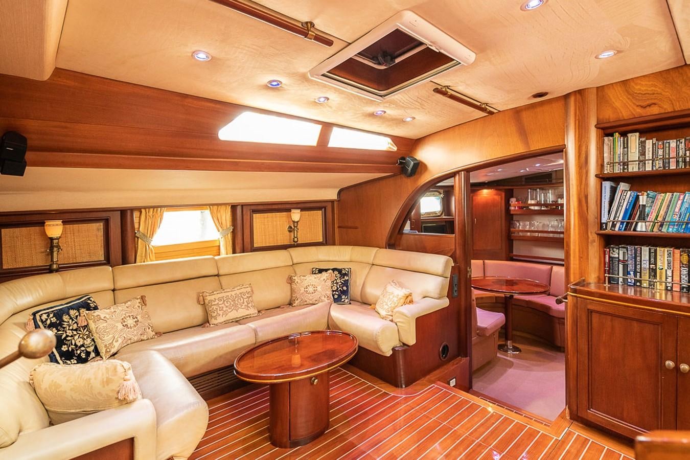 a living room with a couch and a coffee table aboard AURASTEL Yacht for Sale