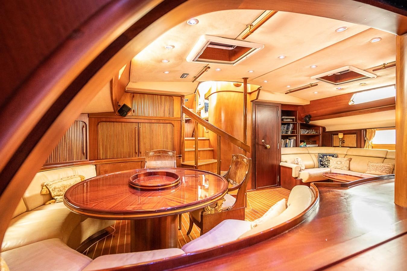 a room with a table and chairs aboard AURASTEL Yacht for Sale