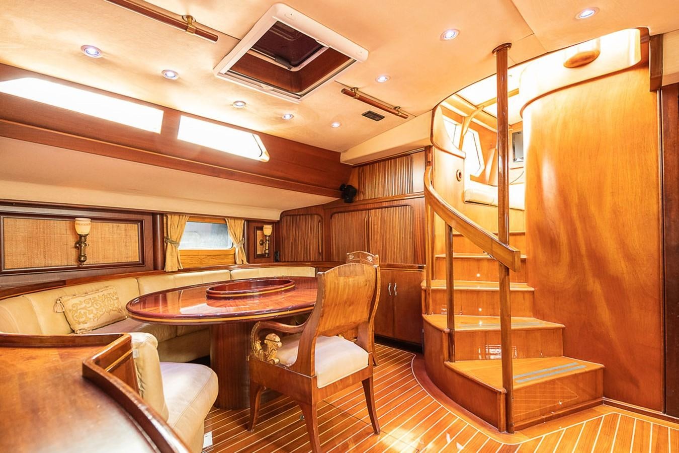 a room with a table and chairs aboard AURASTEL Yacht for Sale