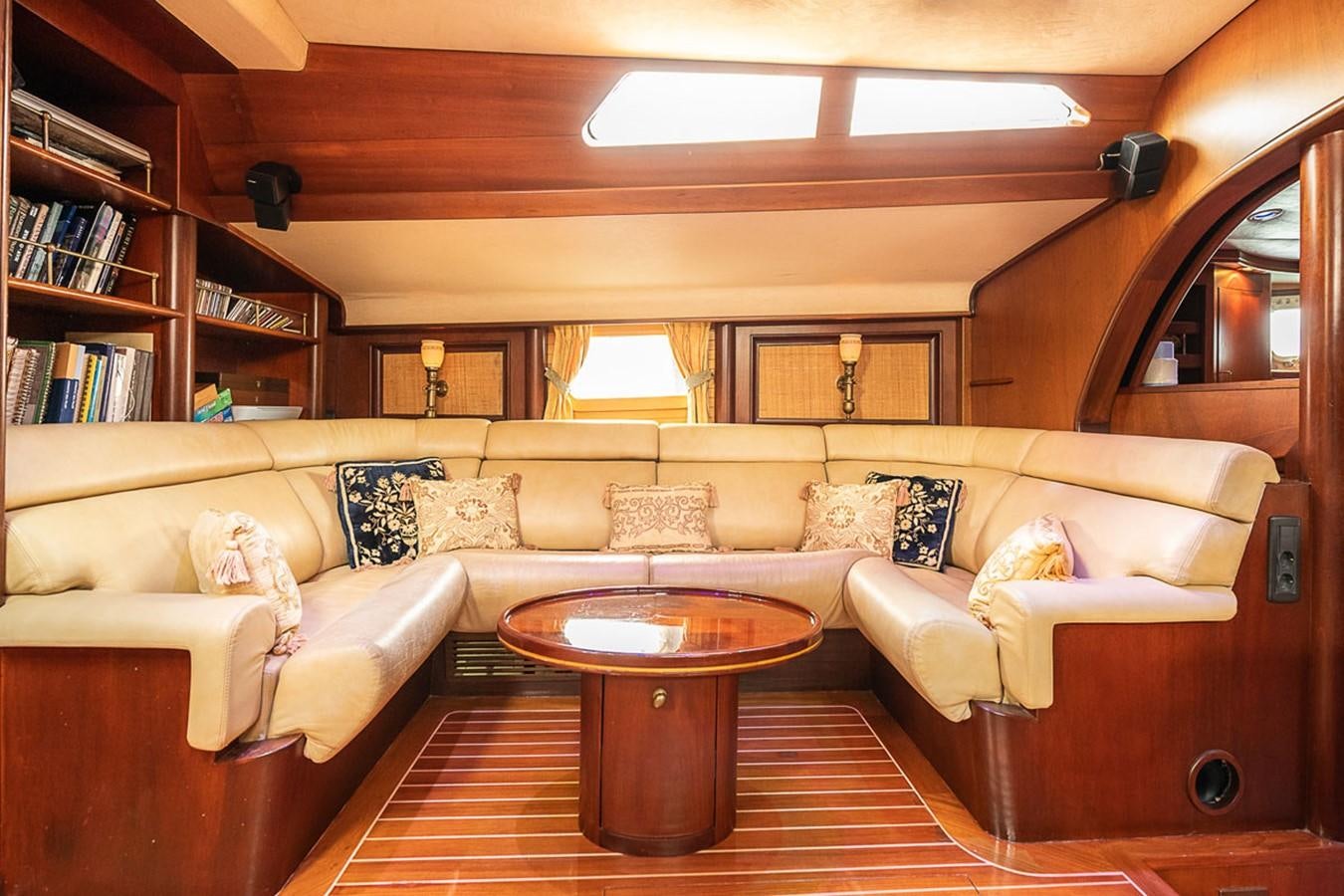 a living room with a couch and a coffee table aboard AURASTEL Yacht for Sale