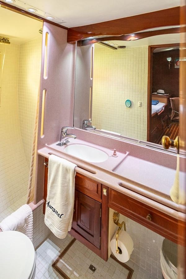 a bathroom with a sink and a mirror aboard AURASTEL Yacht for Sale