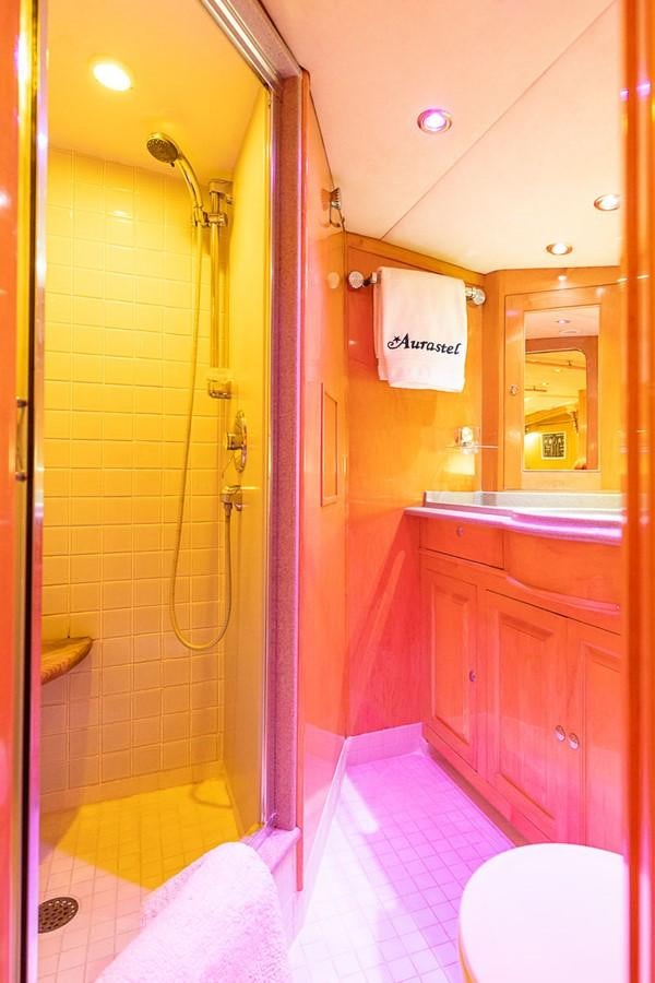 a bathroom with a shower and toilet aboard AURASTEL Yacht for Sale
