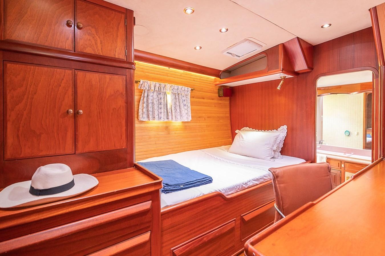 a room with a bed and a table aboard AURASTEL Yacht for Sale