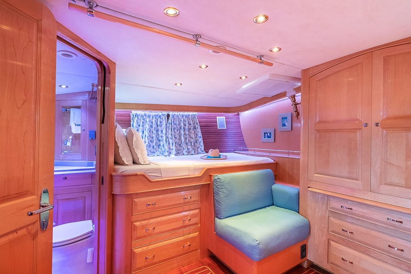 a small bathroom with a blue couch aboard AURASTEL Yacht for Sale