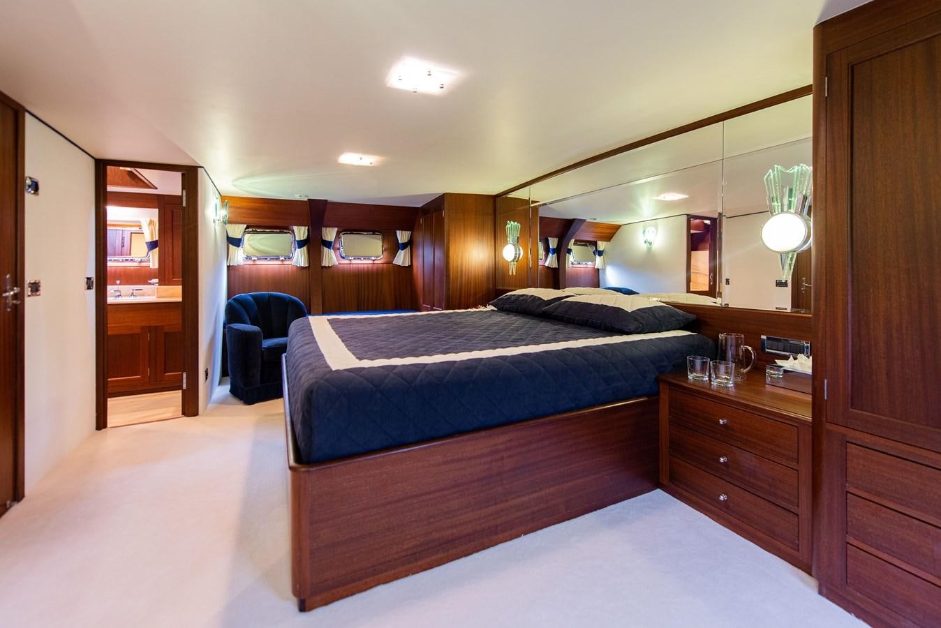 a bedroom with a bed and a desk aboard SANS SOUCI Yacht for Sale