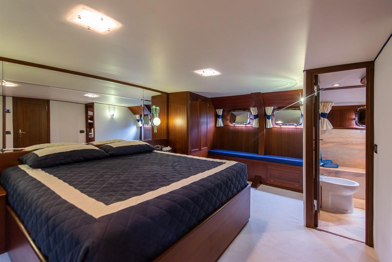 a bedroom with a large bed aboard SANS SOUCI Yacht for Sale