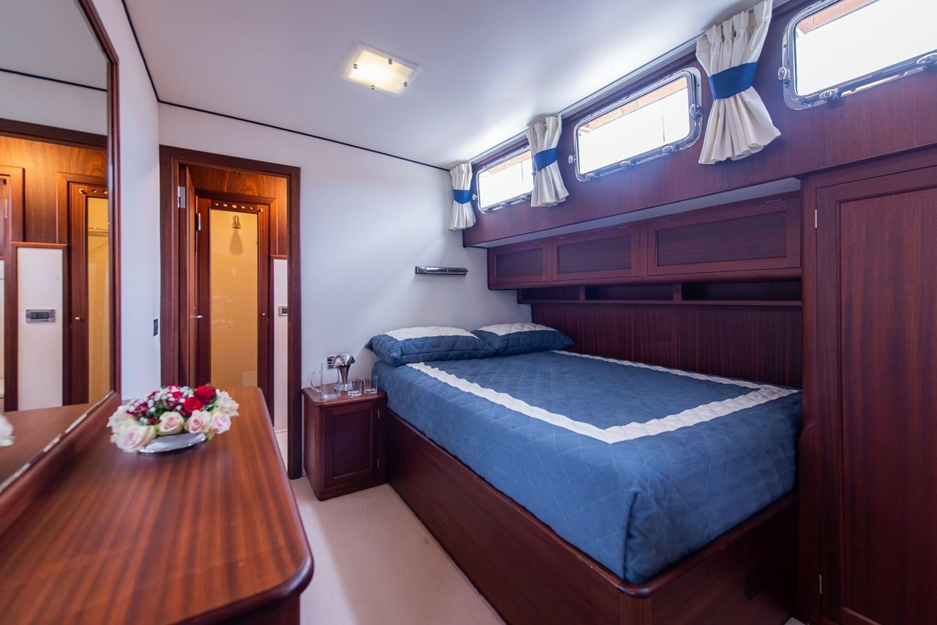a bed with blue sheets aboard SANS SOUCI Yacht for Sale