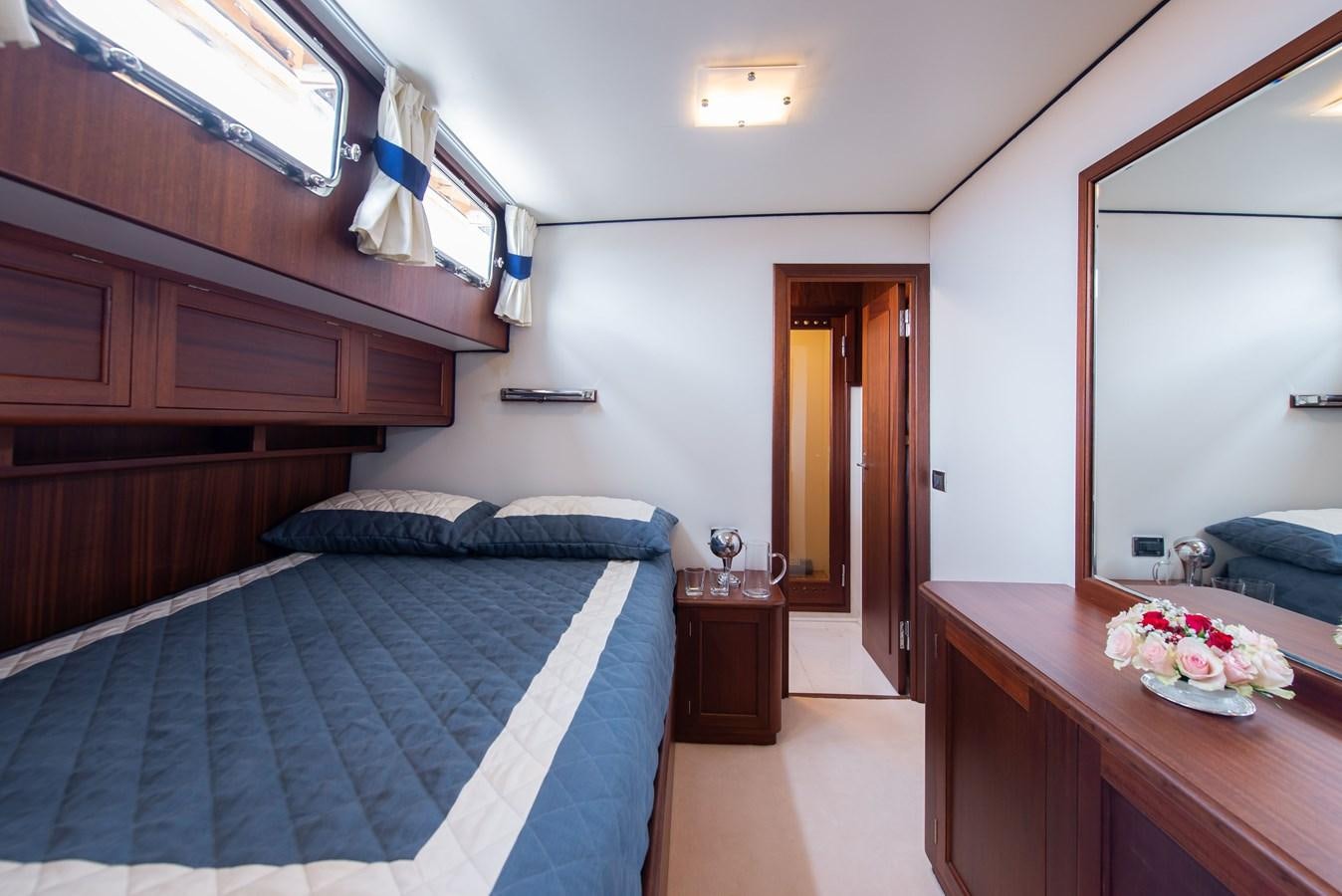 a bedroom with a bed and a desk aboard SANS SOUCI Yacht for Sale