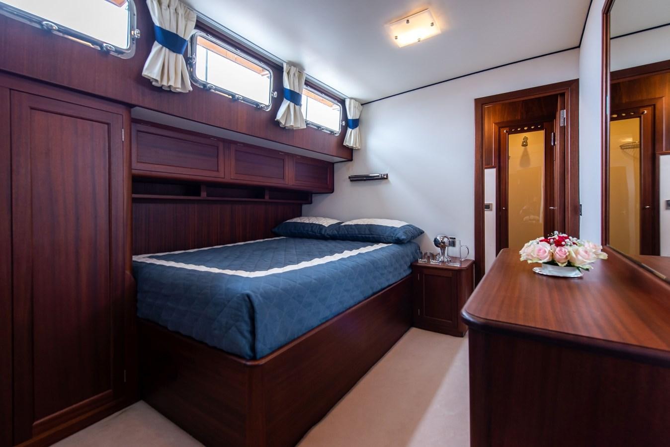 a bedroom with a bed and desk aboard SANS SOUCI Yacht for Sale