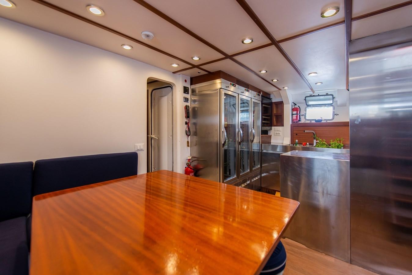a table with chairs and a counter aboard SANS SOUCI Yacht for Sale