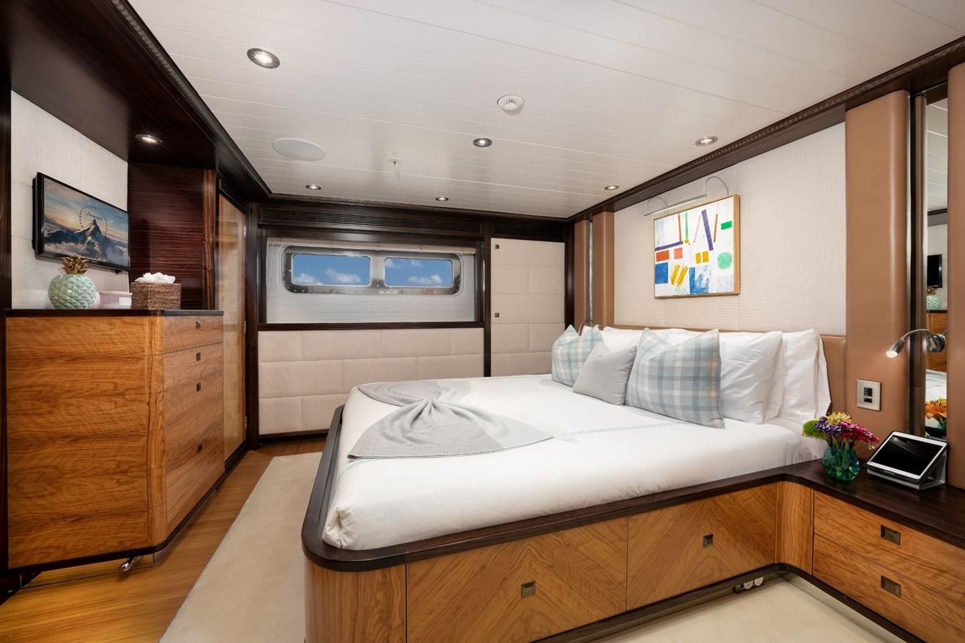 a bedroom with a bed and a desk aboard VESPER Yacht for Sale
