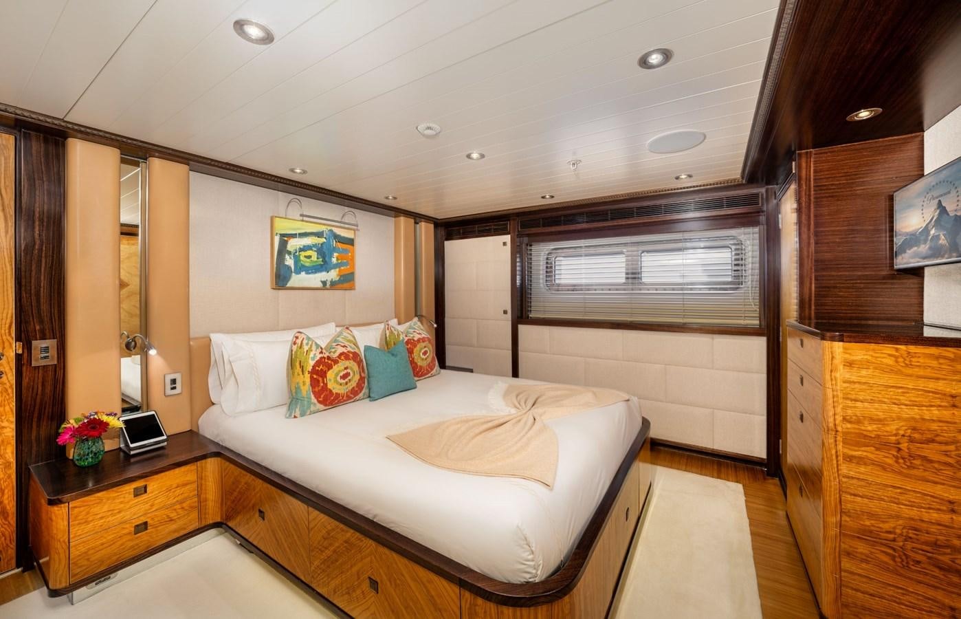a bedroom with a bed and a desk aboard VESPER Yacht for Sale