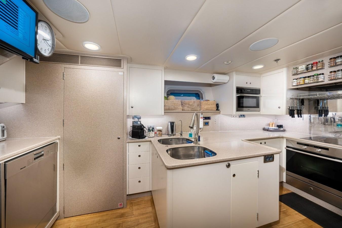 a kitchen with white cabinets aboard VESPER Yacht for Sale