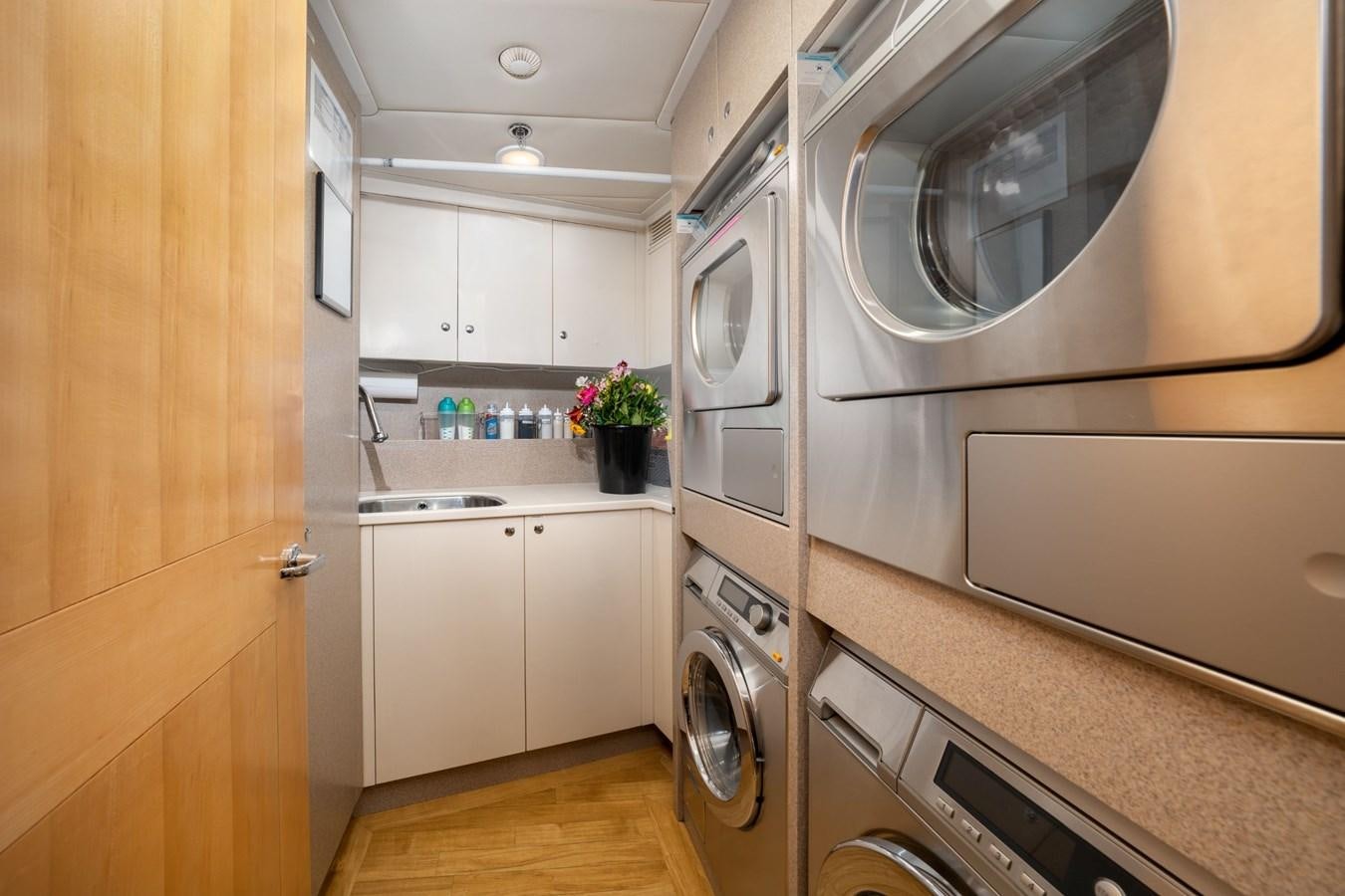a kitchen with white cabinets aboard VESPER Yacht for Sale
