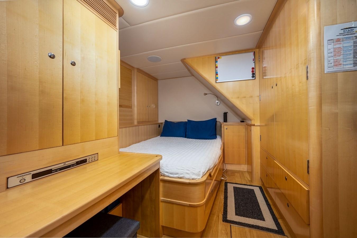 a room with a bed and a desk aboard VESPER Yacht for Sale