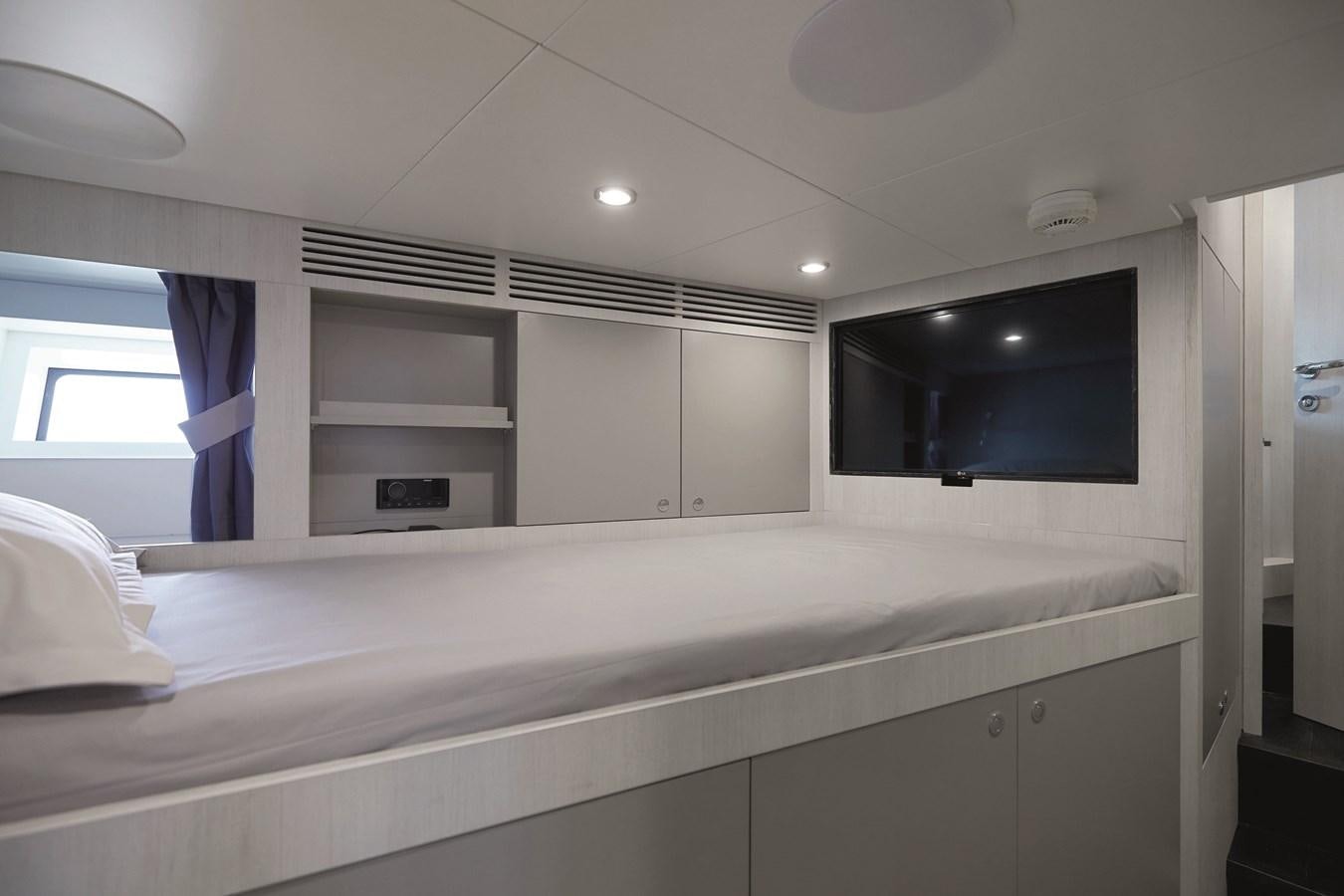 a room with a tv and a shelf with a bookcase aboard AL GASSAR 2022 Yacht for Sale