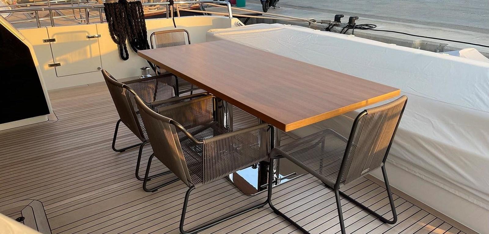 a table and chairs on a boat aboard Y2 Yacht for Sale