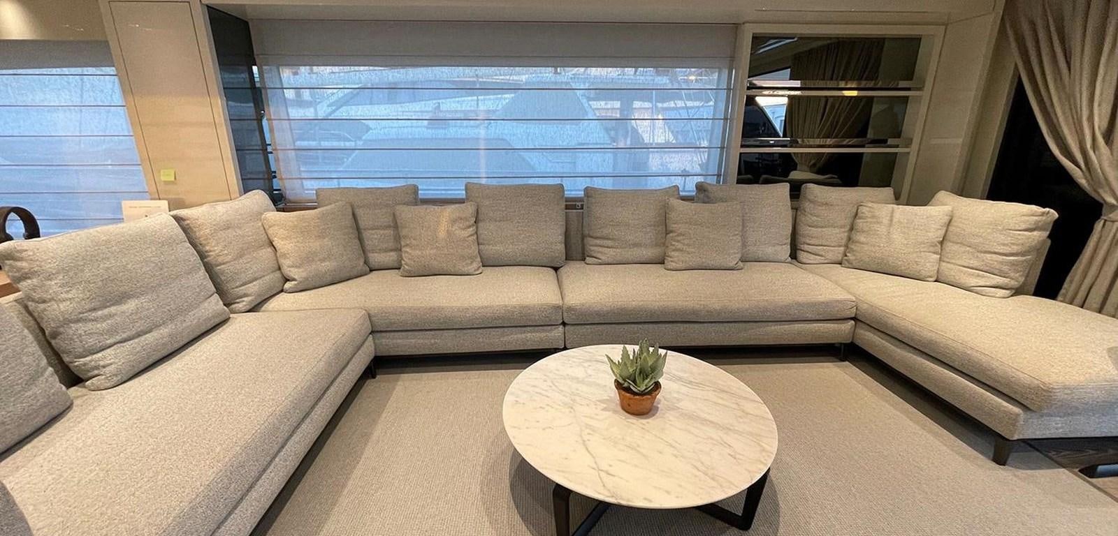 a couch and a table in a room aboard Y2 Yacht for Sale