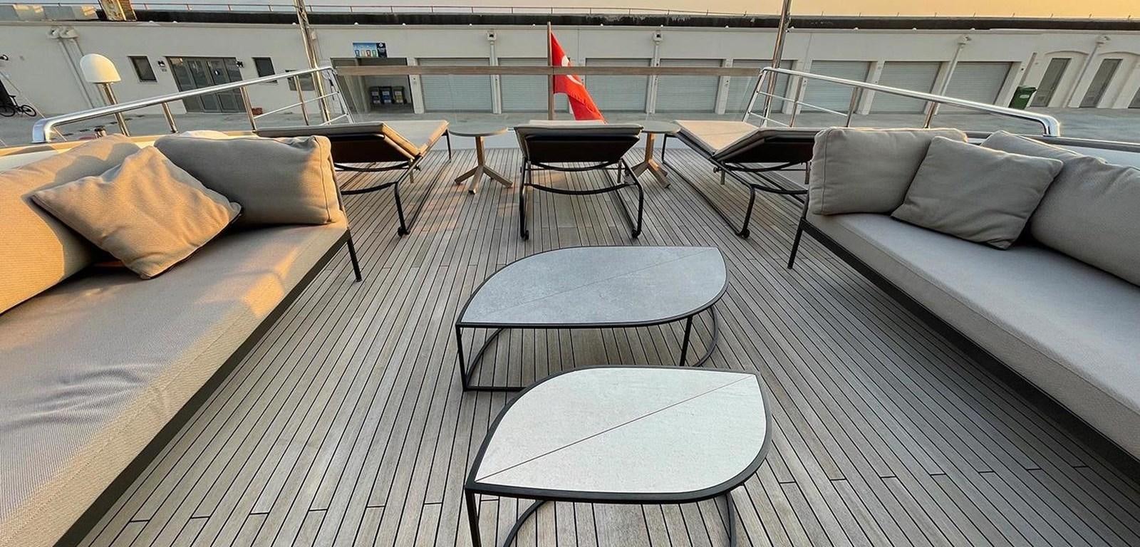 a room with a couch and a table and chairs aboard Y2 Yacht for Sale