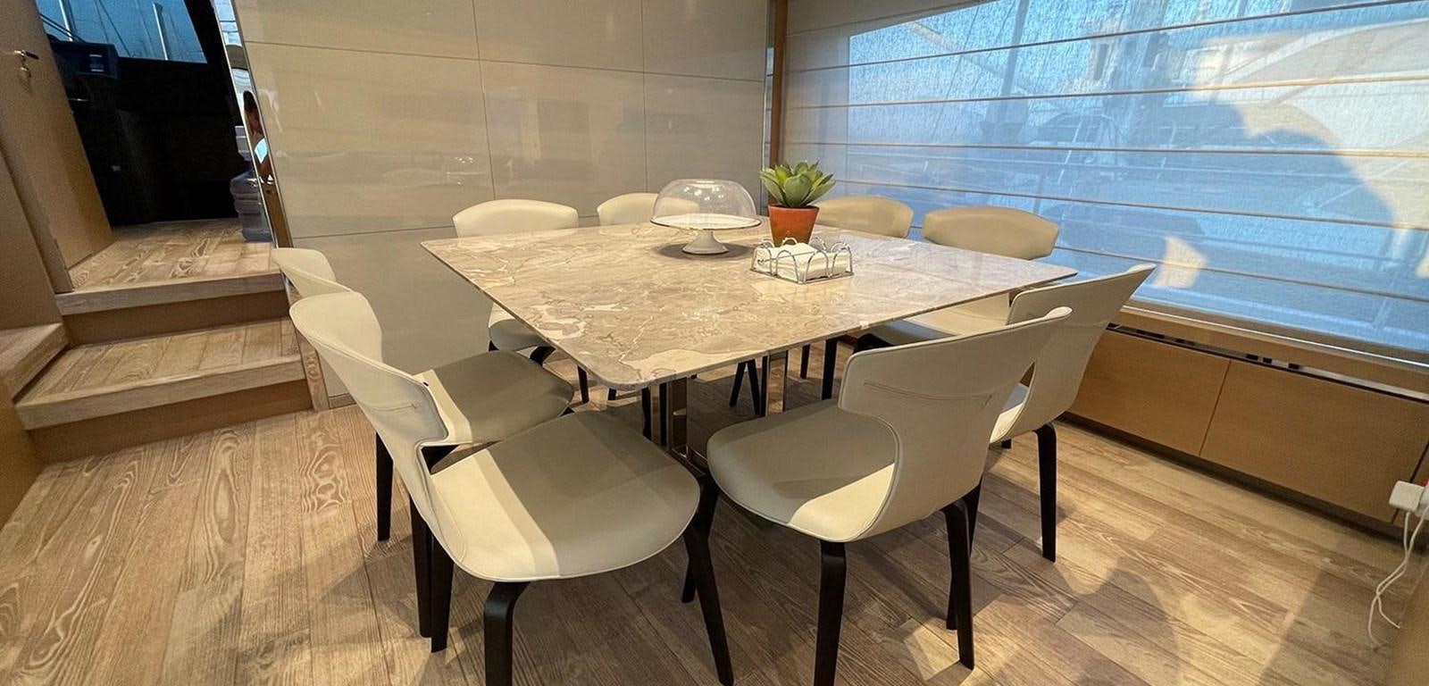 a table with chairs around it aboard Y2 Yacht for Sale