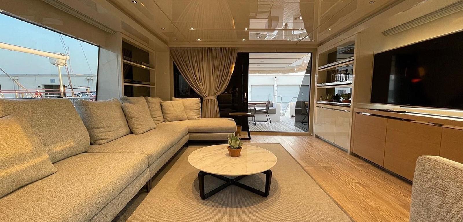 a living room with a couch and a coffee table aboard Y2 Yacht for Sale
