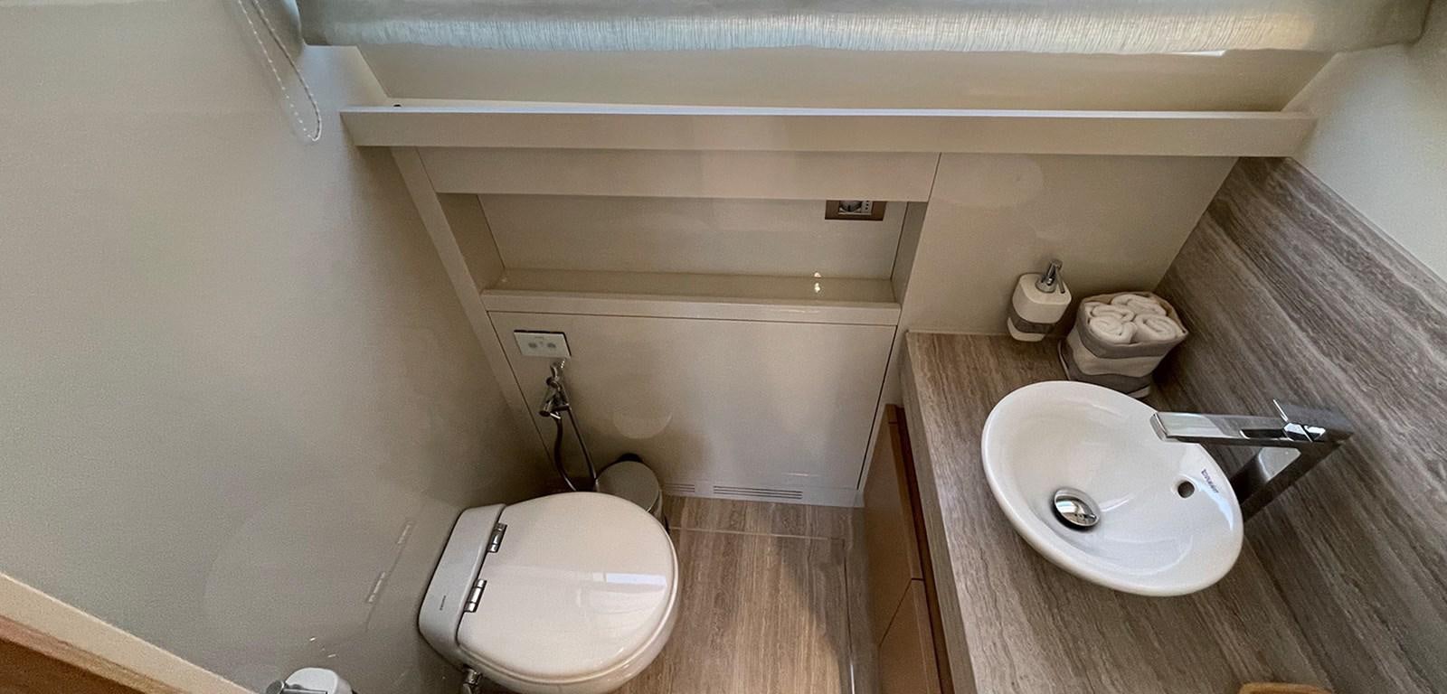 a bathroom with a toilet and sink aboard Y2 Yacht for Sale