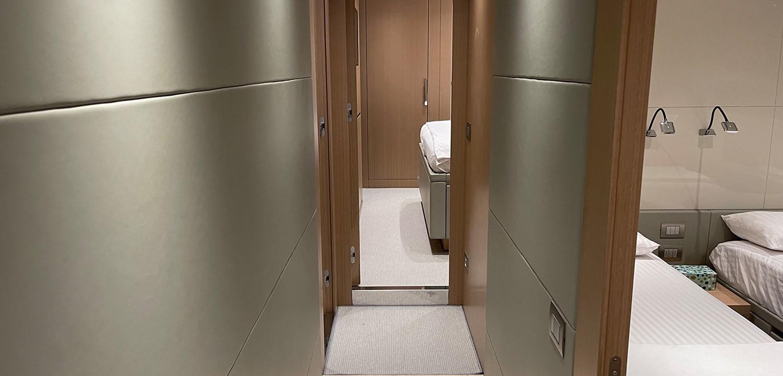 a room with a bed and a refrigerator aboard Y2 Yacht for Sale