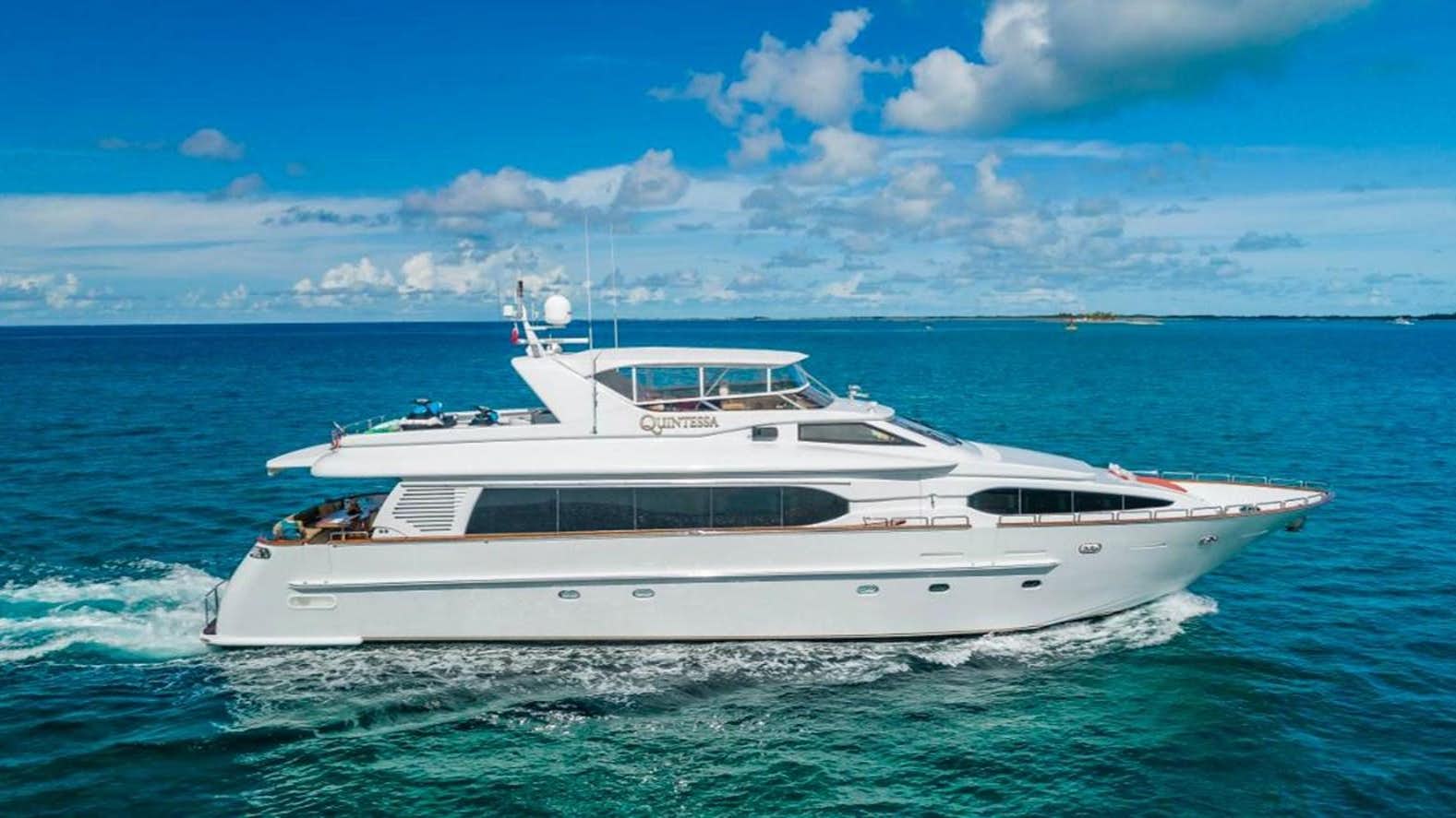 a white yacht in the water aboard QUINTESSA Yacht for Sale