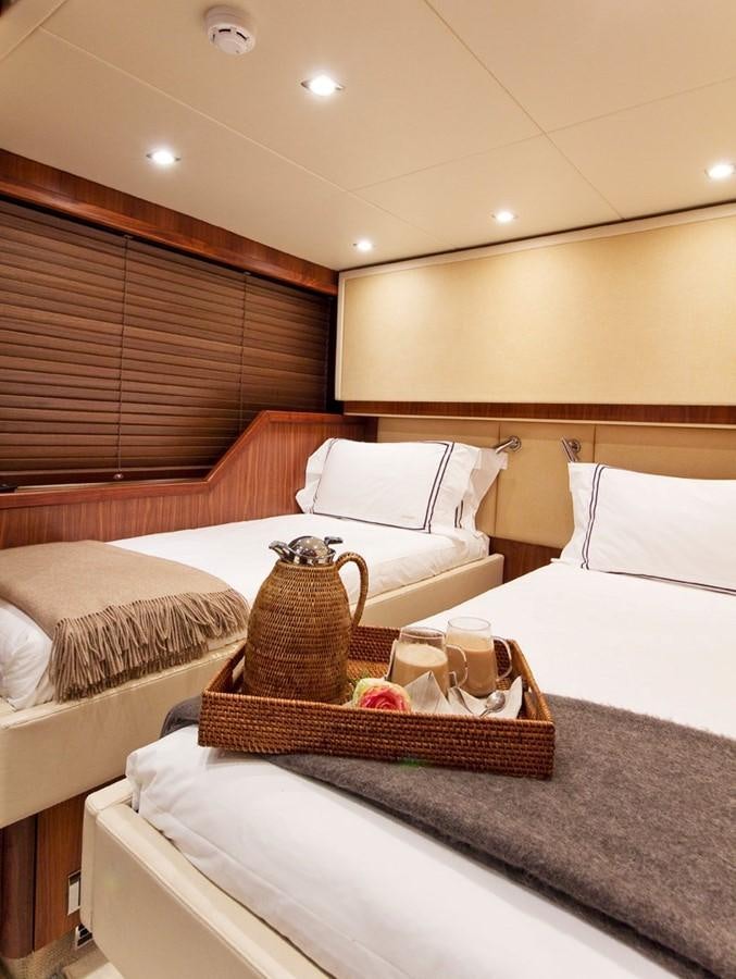 a room with a bed and a coffee table aboard DONIZETTI Yacht for Sale