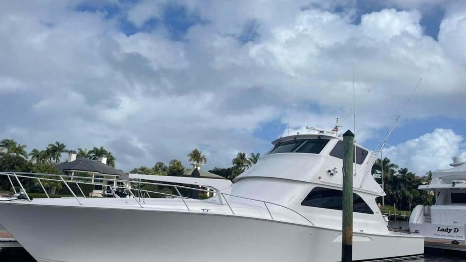 a white yacht in a dock aboard PLAN B Yacht for Sale