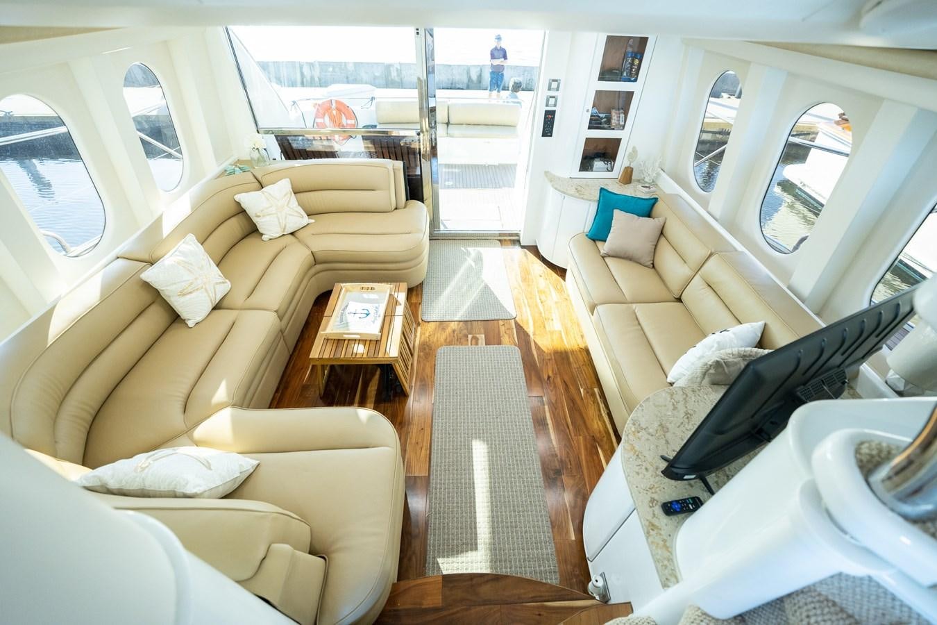 a living room with a wood floor aboard ANGEL DEL MAR Yacht for Sale