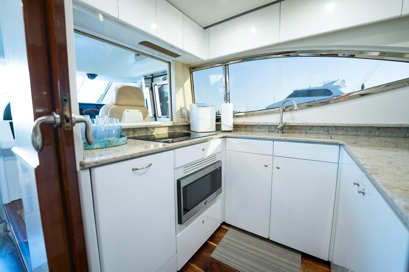 a kitchen with white cabinets aboard ANGEL DEL MAR Yacht for Sale