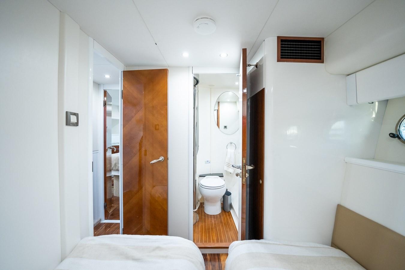 a bathroom with a toilet and a mirror aboard ANGEL DEL MAR Yacht for Sale