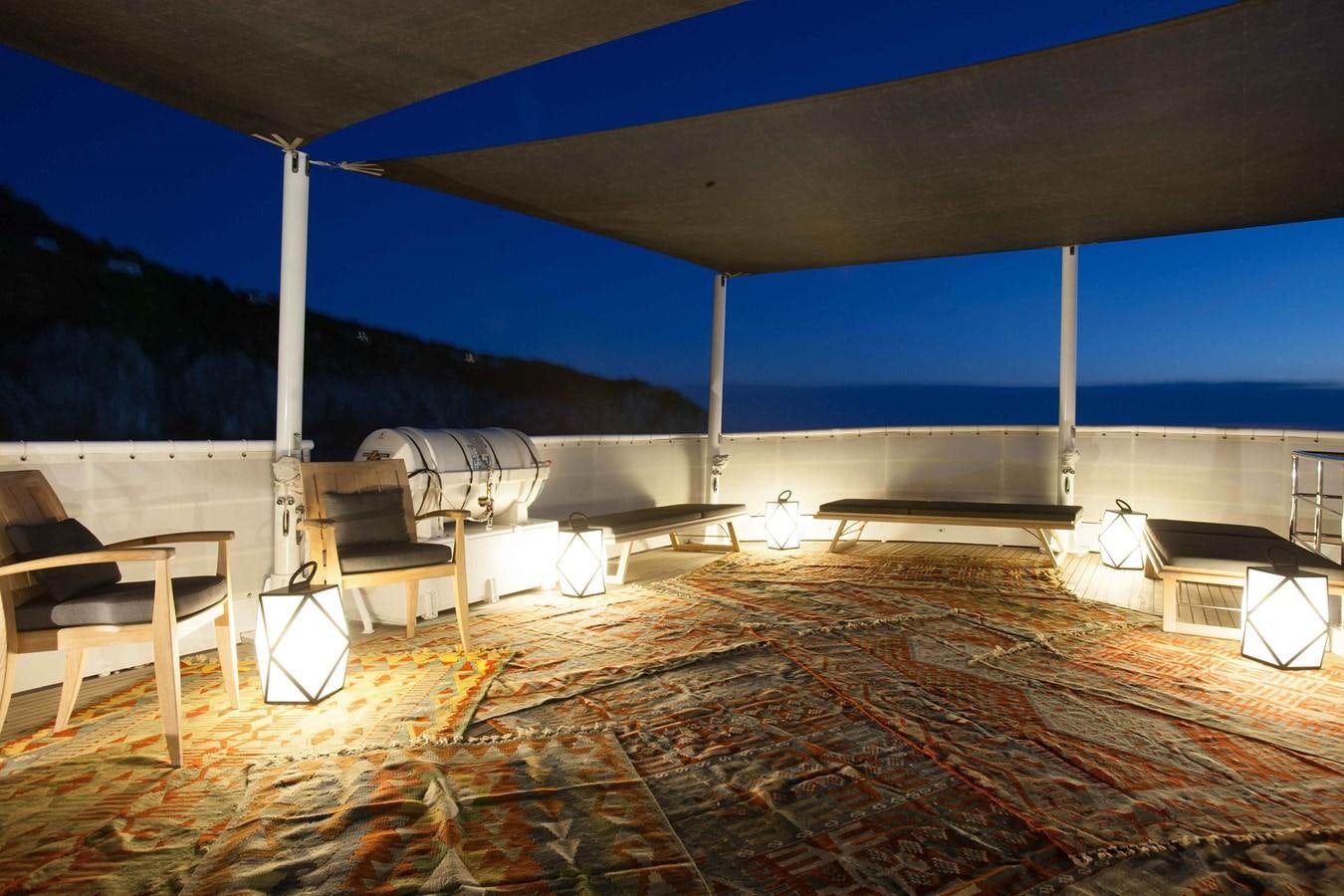 a room with a table and chairs aboard ICE LADY Yacht for Sale