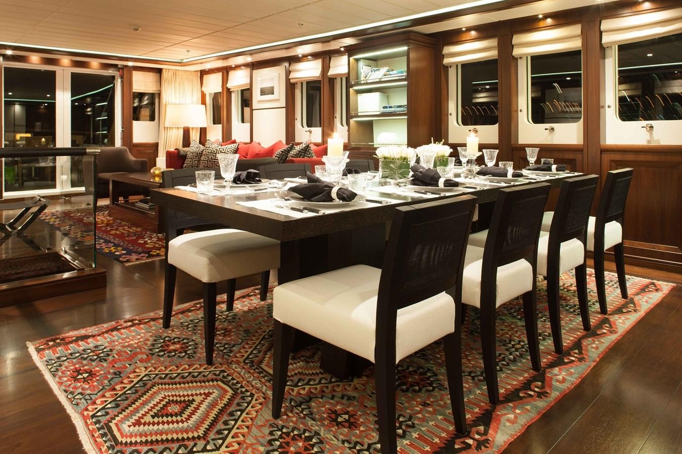 a large dining table in a room aboard ICE LADY Yacht for Sale