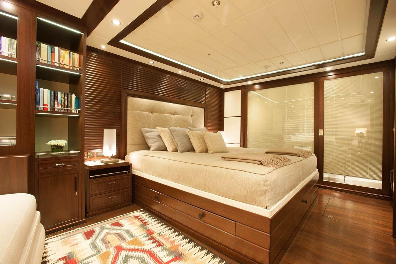a room with a bed and a bookcase aboard ICE LADY Yacht for Sale