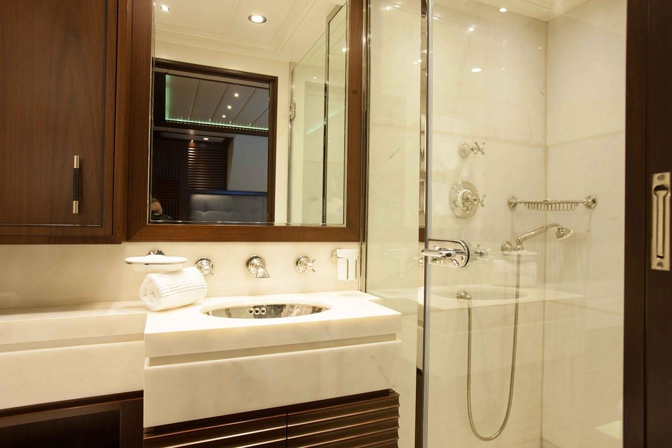 a bathroom with a sink and a shower aboard ICE LADY Yacht for Sale