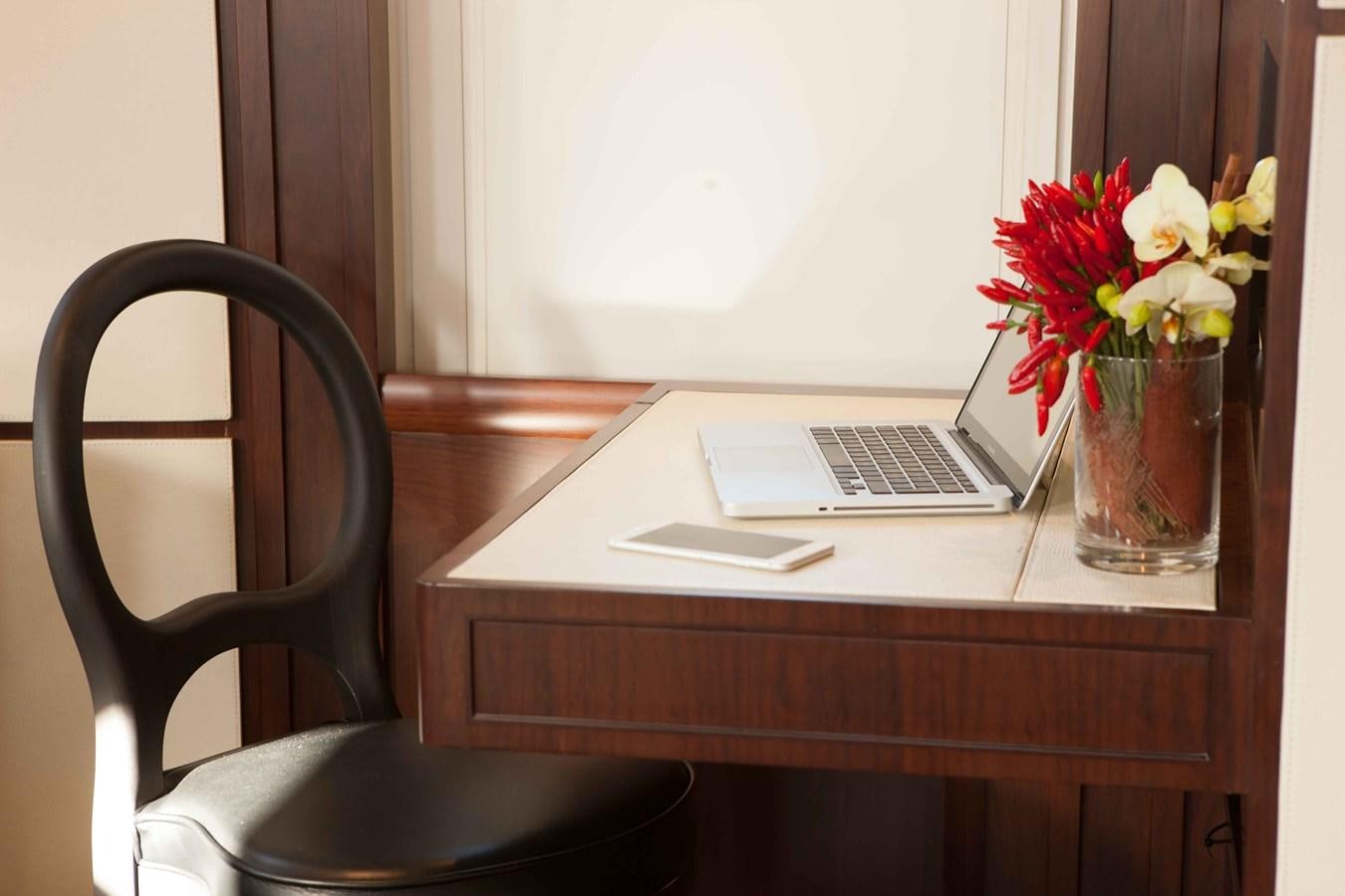 a laptop on a desk aboard ICE LADY Yacht for Sale