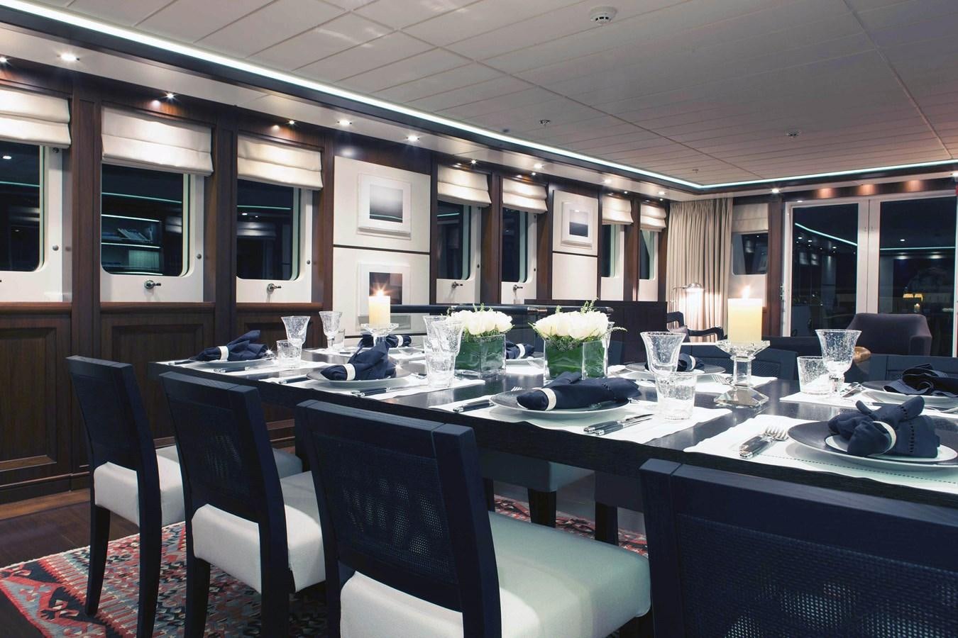 a table with many glasses and plates on it aboard ICE LADY Yacht for Sale