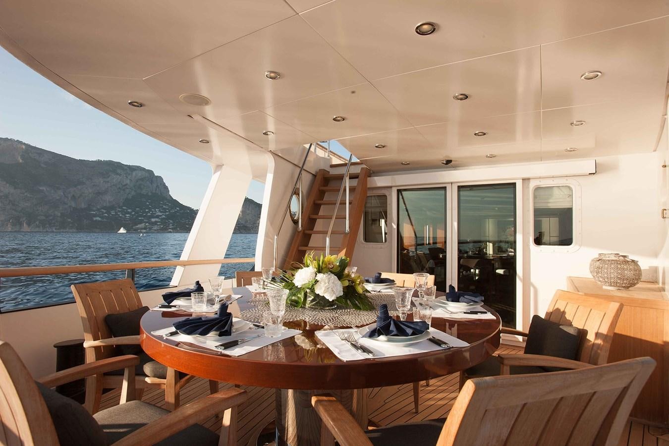 a room with tables and chairs aboard ICE LADY Yacht for Sale
