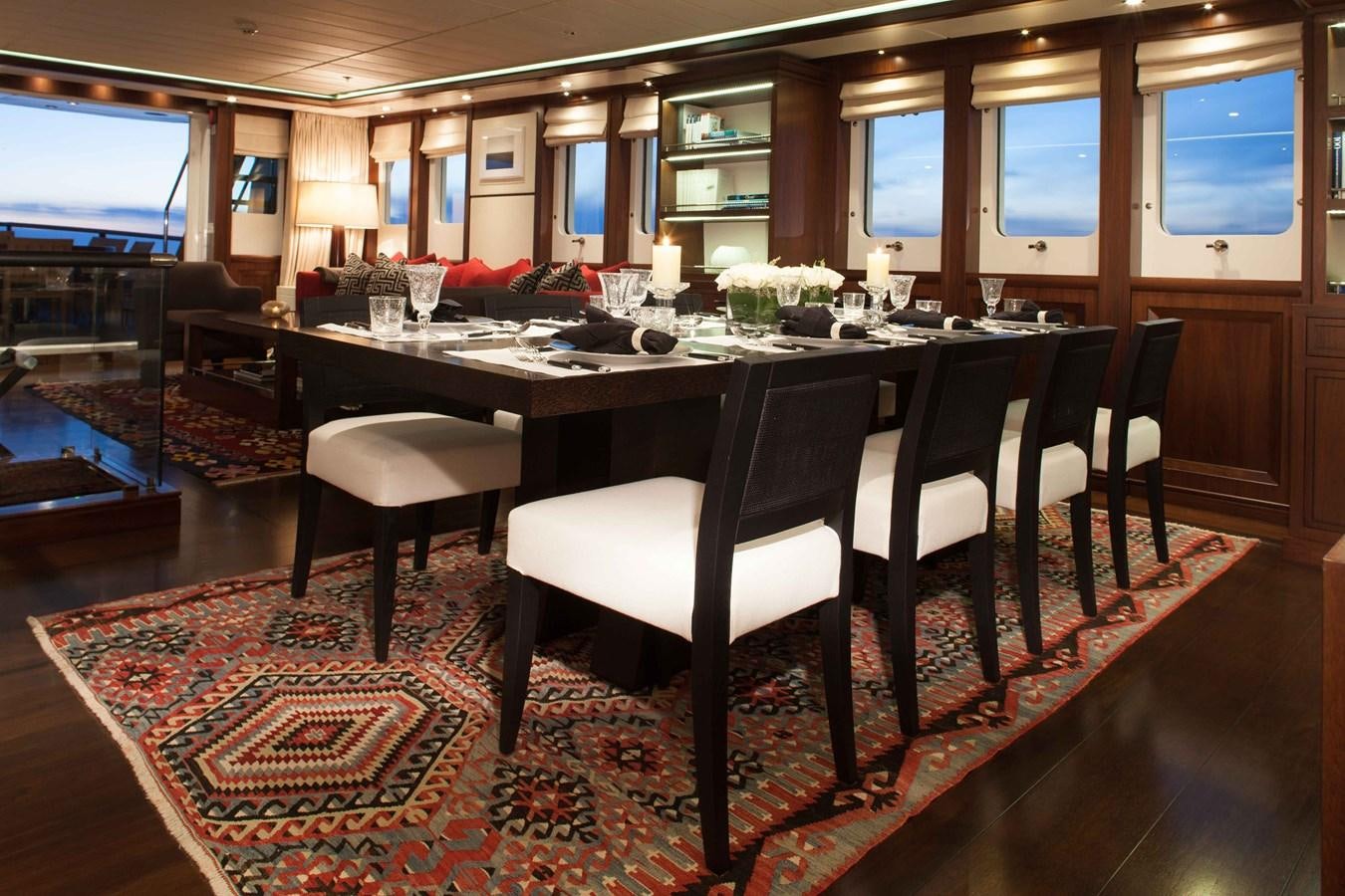 a large dining table with a large screen aboard ICE LADY Yacht for Sale