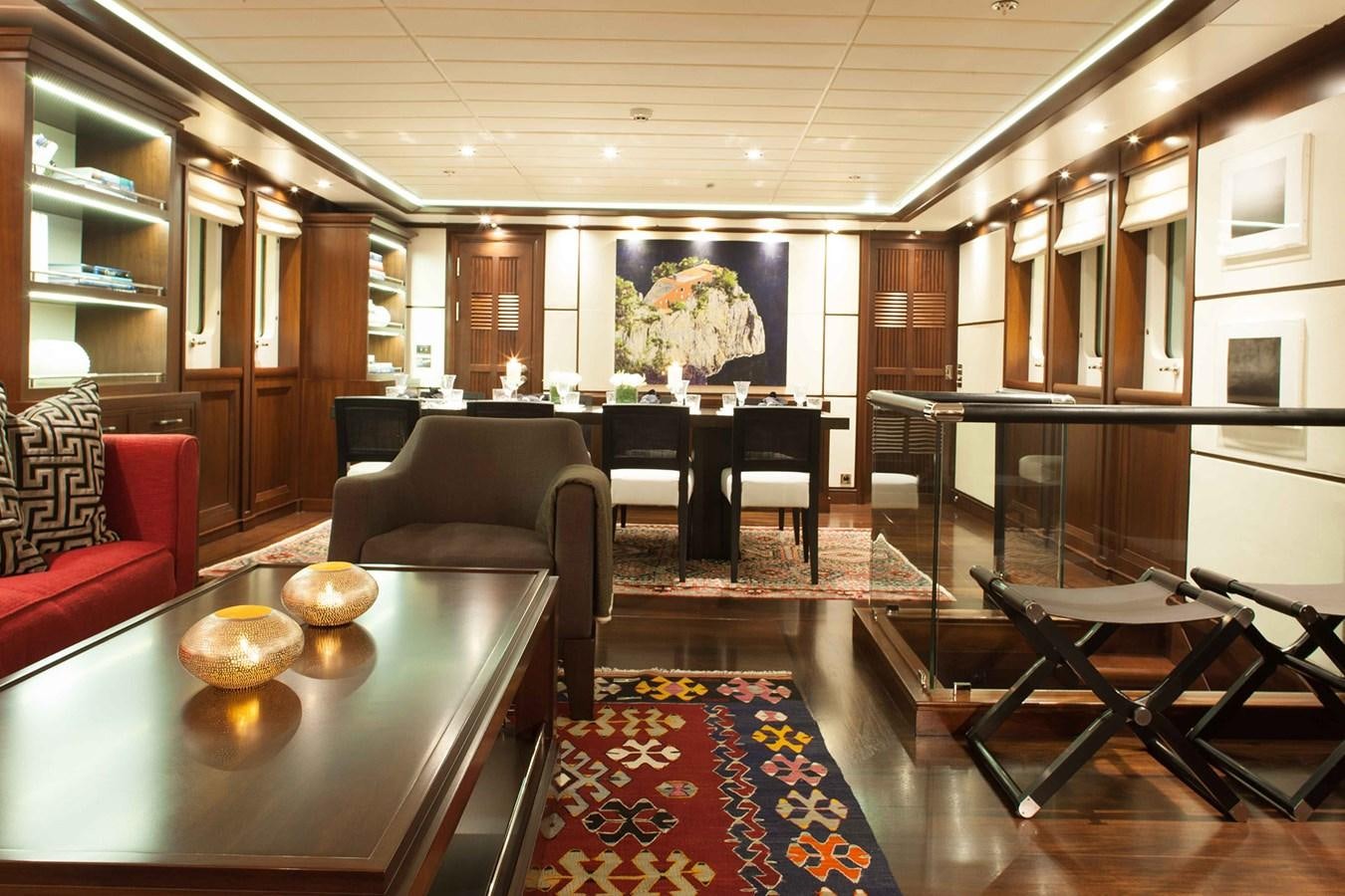 a room with a table chairs and a rug aboard ICE LADY Yacht for Sale