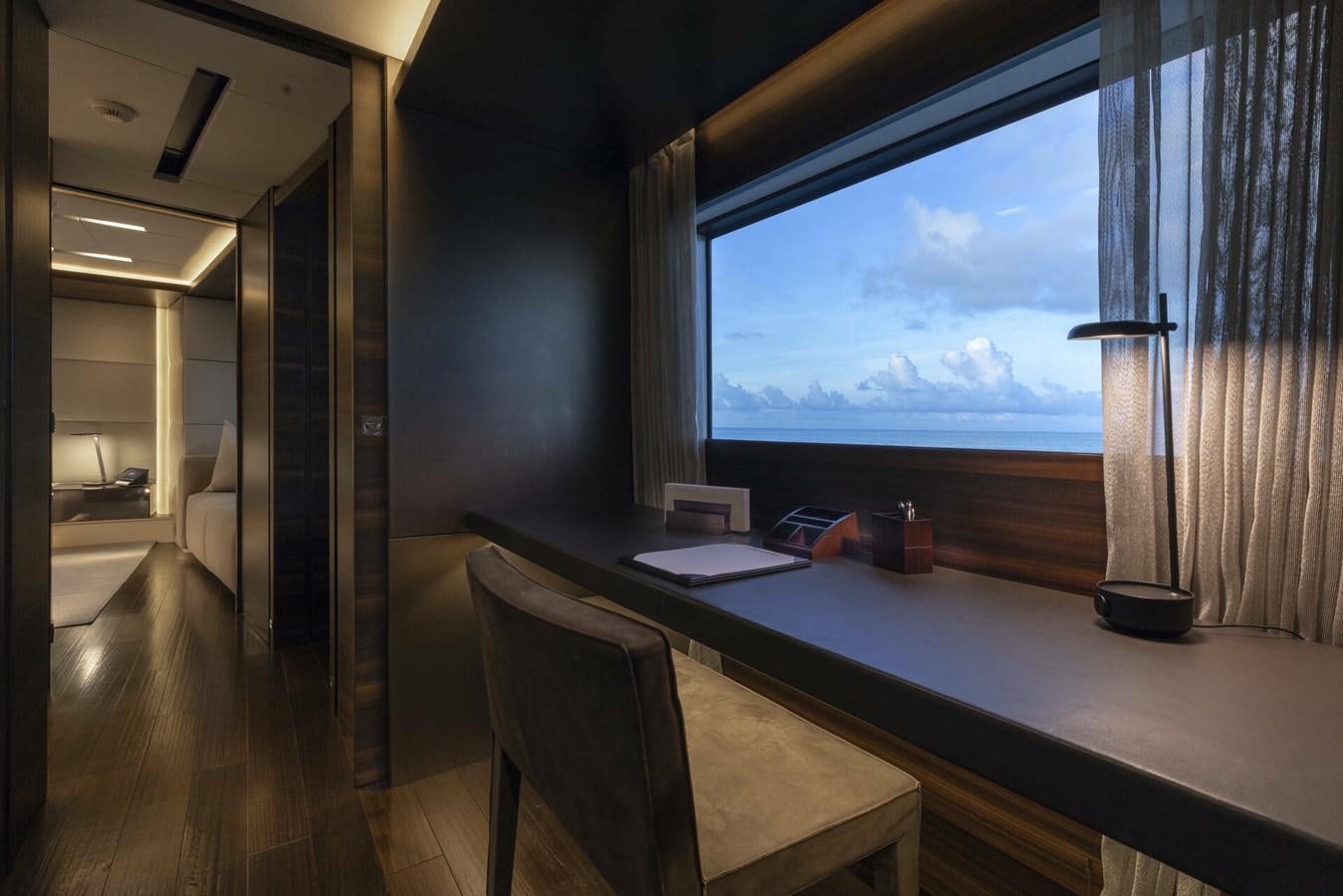 a room with a desk and a window aboard SAFE HAVEN Yacht for Charter