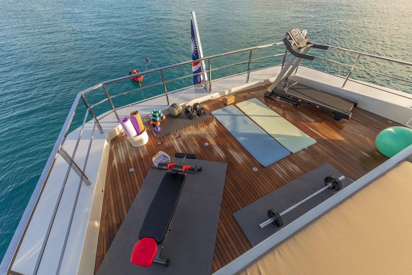 a deck with a deck and chairs aboard SAFE HAVEN Yacht for Charter