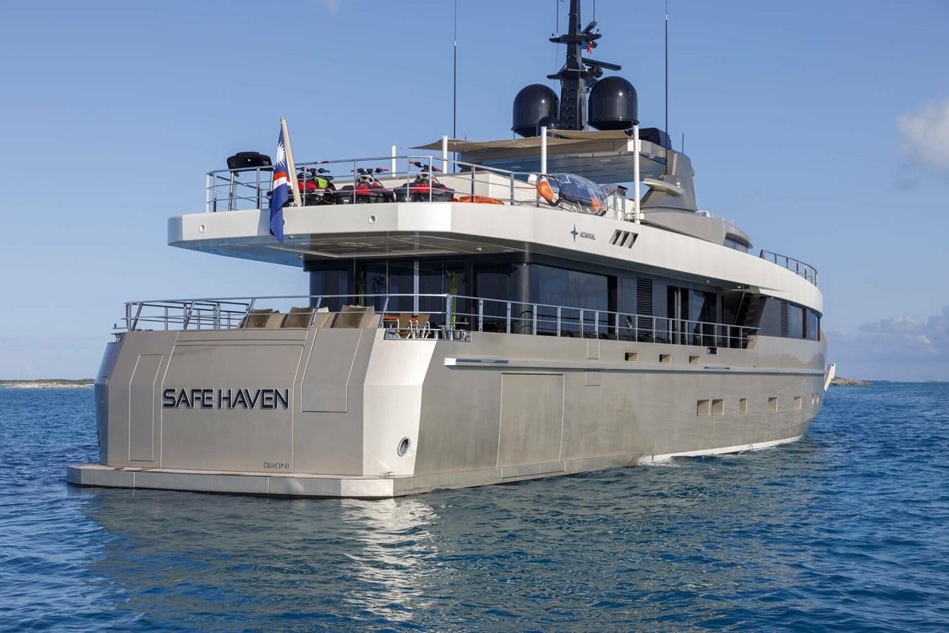 a large white boat on the water aboard SAFE HAVEN Yacht for Charter