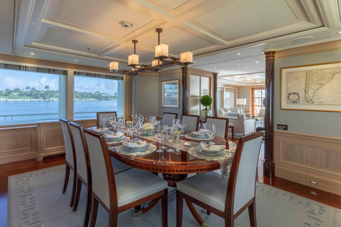 a dining room with a large window aboard FABULOUS CHARACTER Yacht for Sale