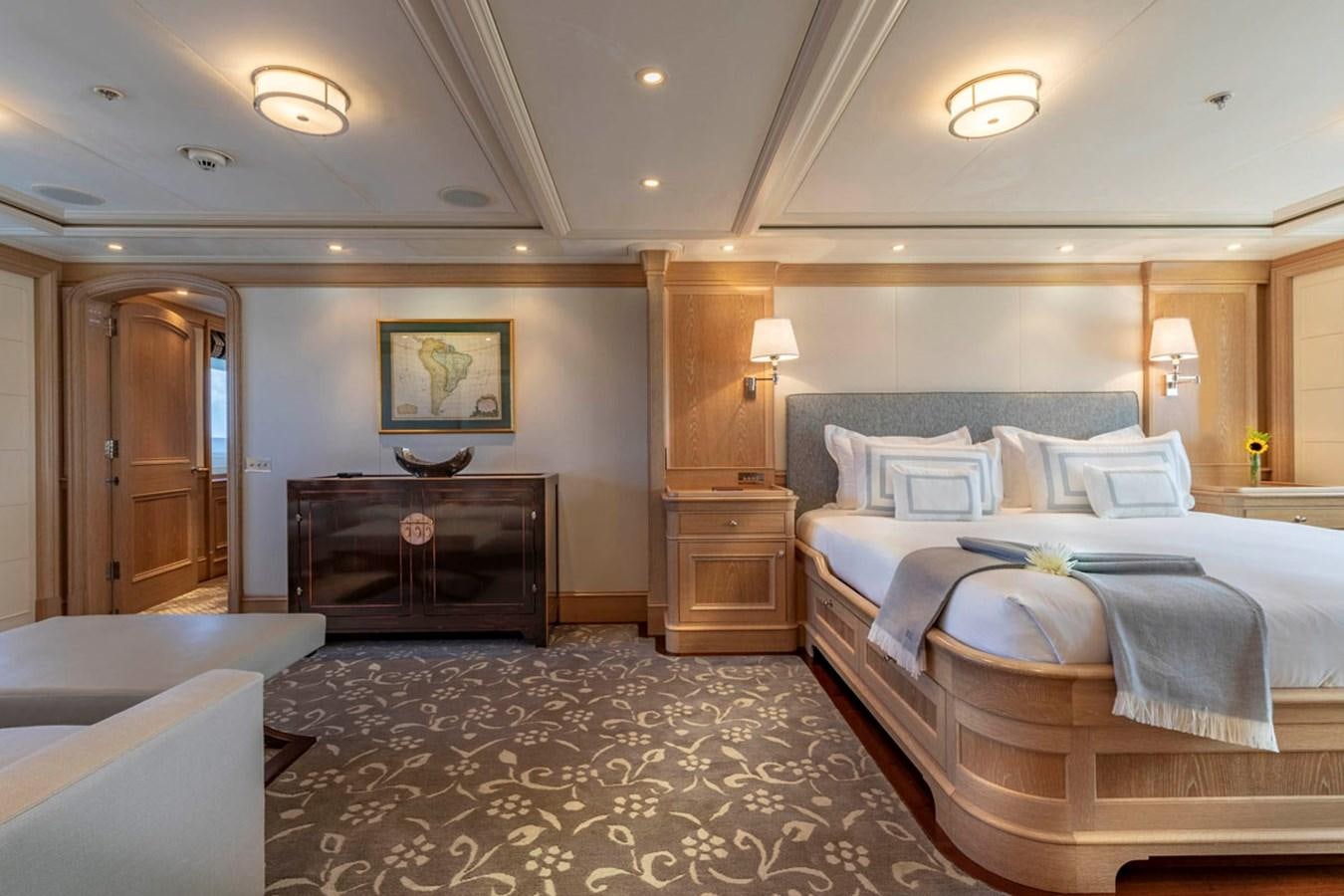a bedroom with a bed and a dresser aboard FABULOUS CHARACTER Yacht for Sale